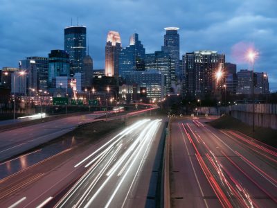 Night has fallen over Minneapolis Minnesota as rush hour traffic still moves on the highways